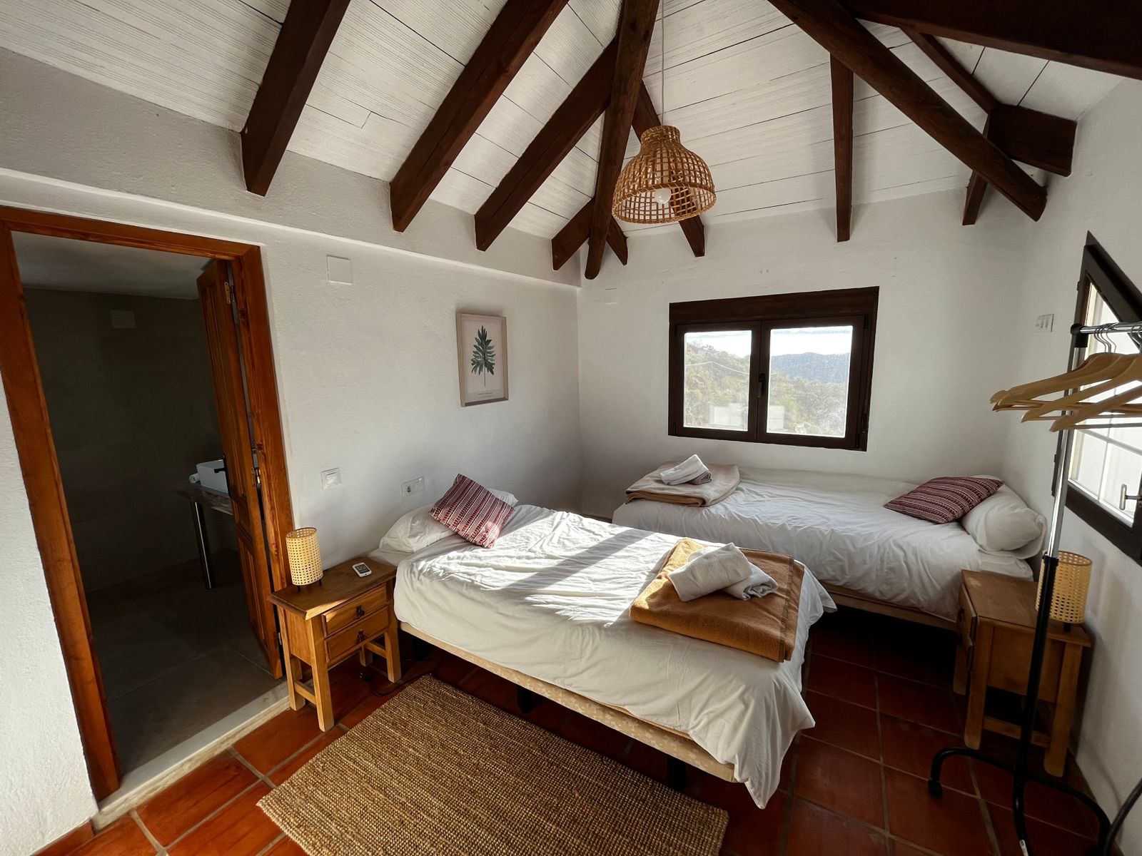 Twin room with wooden beams and mountain views, with its own bathroom