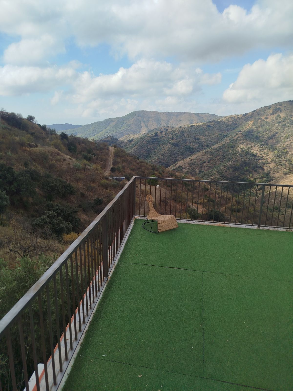 Lawn terrace with a railing, looking over the mountains
