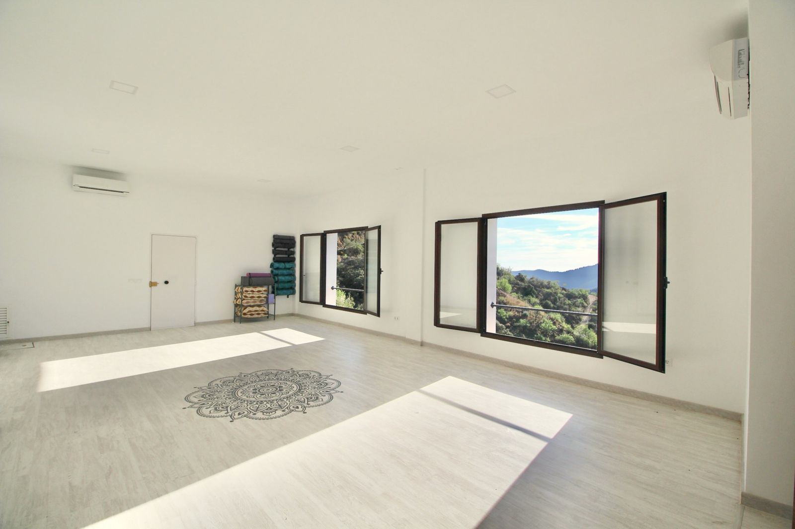 Bright studio with open windows onto the mountains